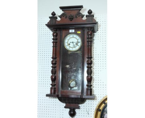 A Victorian wall clock in polished as mahogany case decorated split turned pilasters