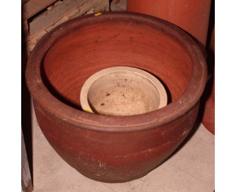 A stoneware circular garden planter and a smaller glazed planter