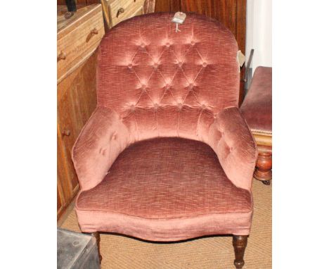 A Victorian low seat armchair, button upholstered in a pink velour