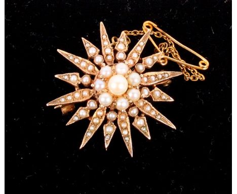 An unmarked seed pearl set sunburst brooch/pendant