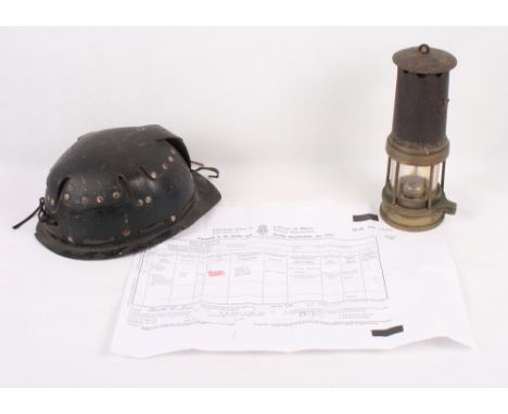 A miner's early 20th Century safety lamp and helmet, formerly the property of William Howlett, a survivor of the Senghenydd M