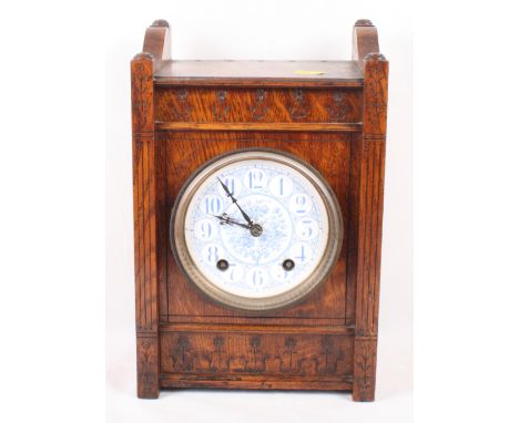 An Aesthetic style oak cased mantel clock, blue and white ceramic dial, 13" high