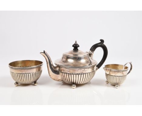 Late Victorian / early Edwardian composite silver bachelors three piece tea set comprising teapot of half-fluted form, with b