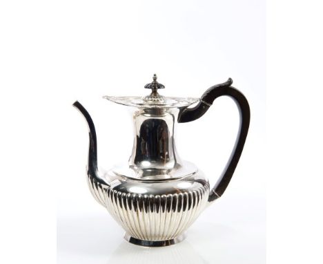 Early Edwardian silver coffee pot of half-fluted baluster form, with shell and floral border, ebony loop handle with carved l