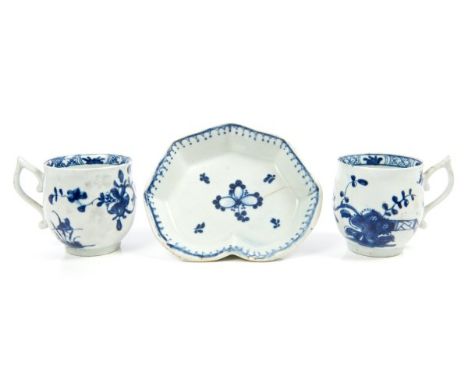 Pair of early Worcester cups of barrel form, with wishbone handles, circa 1760, painted in blue with Chinese fence, flowering