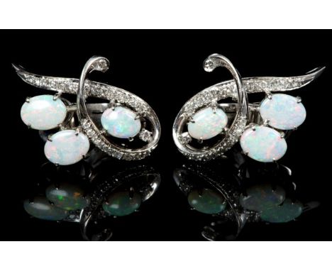 Pair of opal and diamond cocktail earrings, each with three oval opal cabochons within a diamond set scroll, with precious wh