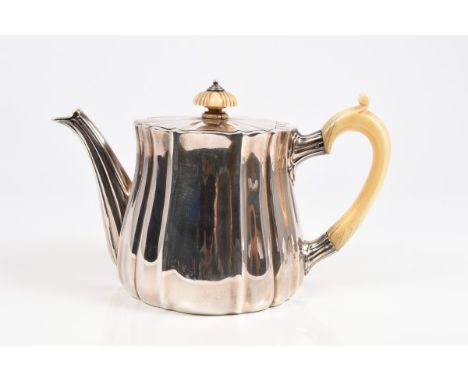 Edwardian silver teapot of compressed baluster form, with panelled decoration, ivory scroll handle and flush-fitting hinged c