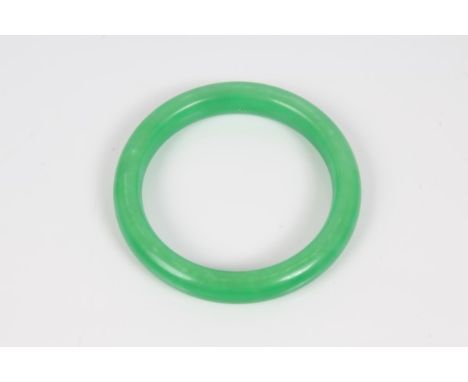 Chinese jade / green hardstone bangle CONDITION REPORT Approximately 5.5cm diameter.  Unsure whether the colour is natural or