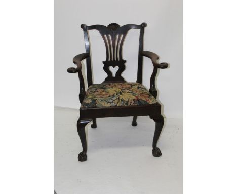 George III, probably Irish, mahogany open elbow chair with shell cresting above pierced splat back, scroll arms terminating i