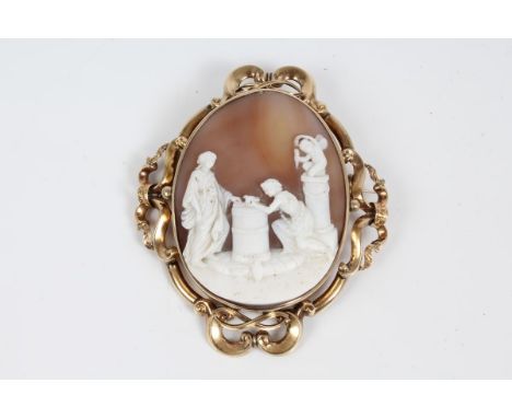 19th century Italian carved shell cameo brooch, the oval panel relief carved depicting a classical figure group, in a yellow 
