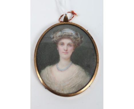 Annie Underwood (1876 - 1942), portrait miniature on ivory - a lady in white dress, signed with monogram, inscribed on revers