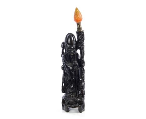 Early 20th century Chinese carved hardwood and ebonised figure table lamp of the God of Longevity Shou Lao holding a staff an