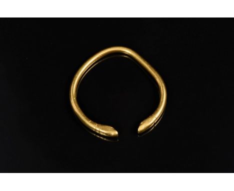 Indian yellow metal torque bangle with snake head terminals CONDITION REPORT Total gross weight approx 64 grams.  Believed to