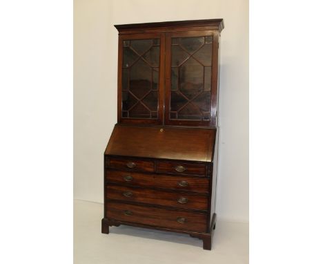 George III mahogany two height bureau bookcase with shelves above, enclosed by two astragal glazed doors, fitted interior, tw