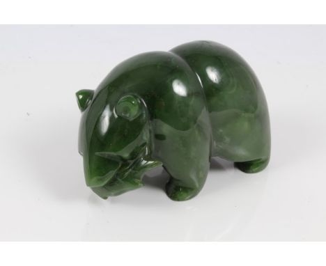 Carved jade figure of a polar bear, modelled standing, a fish in its mouth