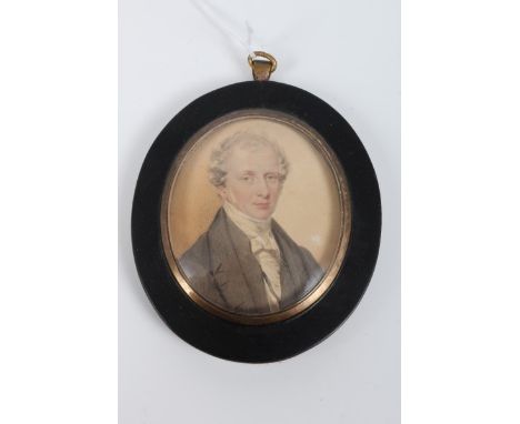 Attributed to Fisher, early 19th century watercolour portrait on paper of a gentleman wearing a cravat and black coat, in ebo