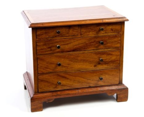 Georgian-style miniature walnut chest with crossbanded top, two short and three long graduated drawers with brass bun handles