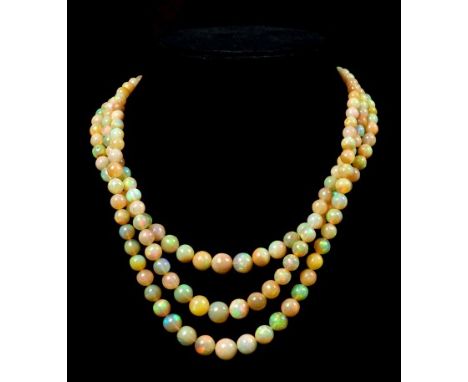 Opal bead three strand necklace with three strings of graduated polished spherical opal beads, on a precious yellow metal cla