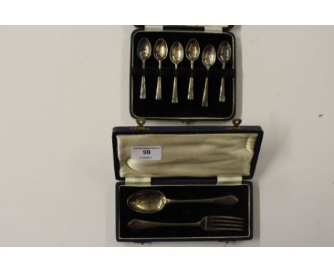 A cased set of six silver coffee spoons; and a cased silver fork and spoon 