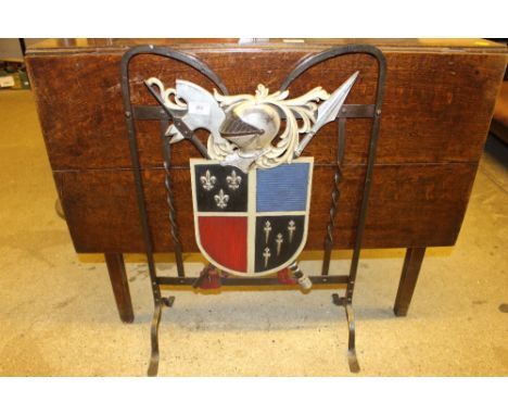 A firescreen decorated with heraldic crest 