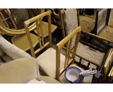 A pair of light wood bedroom chairs 