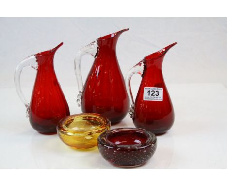 Three Ruby glass Sparrow beak Whitefriars jugs and two Controlled bubble bowls, tallest jug approx 19cm tall