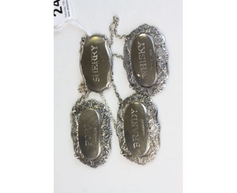 Three Hallmarked Silver decanter labels plus a white metal example