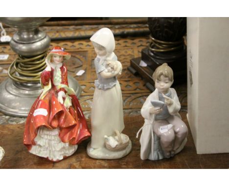 Royal Doulton figurine 'Top o' The Hill,' a Nao figure of a girl putting on lipstick &amp; a Nao boxed figure of girl with pu