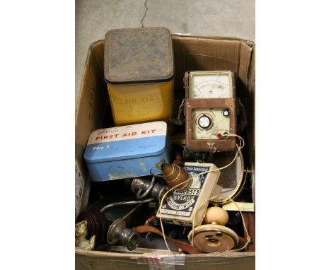 Box of assorted items to include a cased pair of binoculars, voltmeter, radio, vintage tins etc
