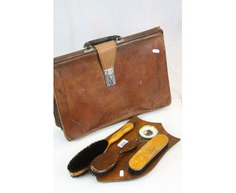Mid 20th century leather attache case, together with an oak shield barometer with clothes brushes