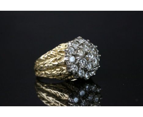 Diamond three tier yellow metal cluster ring, the central round brilliant cut diamond weighing approximately 0,20 carat, tota
