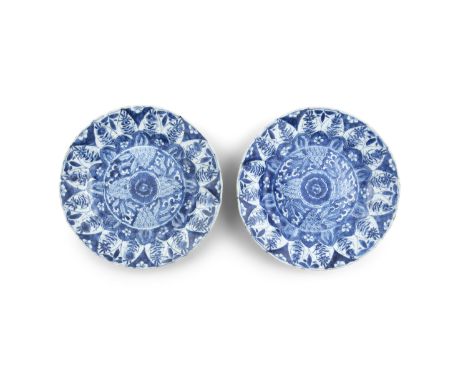 A PAIR OF CHINESE BLUE AND WHITE DISHES, Kangxi (1667 - 1722), each with central floral medallion encircled by a band of lapp