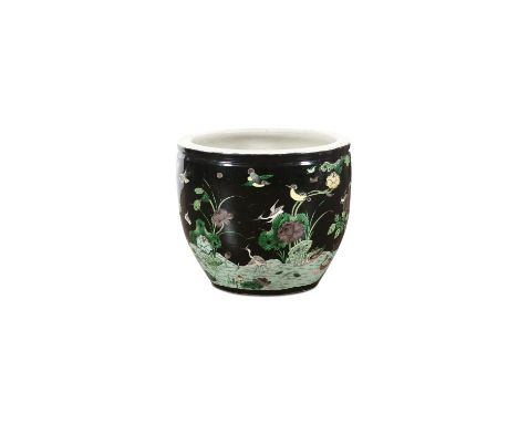 A CHINESE FAMILLE NOIRE JARDINIÈRE, Late 19th century, of deep circular form, decorated with exotic birds flying above lotus 