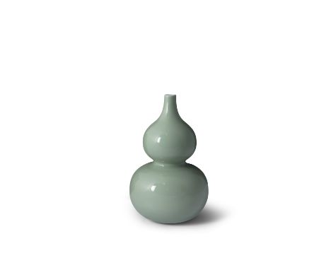 A FINE CHINESE CELADON GLAZED DOUBLE GOURD VASE, Qianlong (1736 - 1795), evenly covered in a soft pale tone, formed with a co