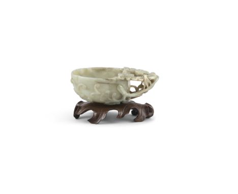A CHINESE JADE 'MELON' LIBATION CUP, 18th century, of pale celadon tone with small brown inclusions, formed as a hollowed mel
