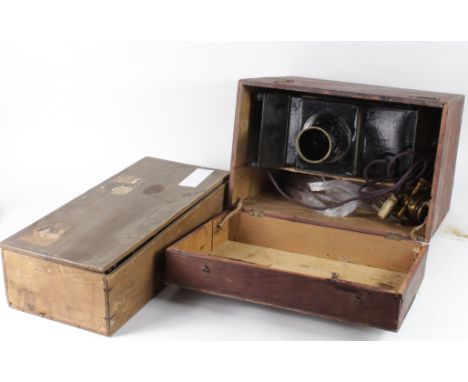 Magic Lantern. A magic lantern in a wooden case, together with a collection of approximately forty-two glass slides, includin