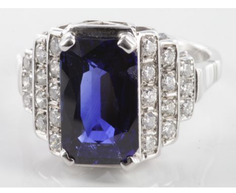 18ct white gold fine emerald cut sapphire dress ring with step down diamond shoulders, size N, weight 4.8g.