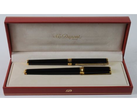 S. T. Dupont. Two black S. T. Dupont pens, comprising a Laque de Chine fountain pen (18ct Gold nib, clip encrusted with stone