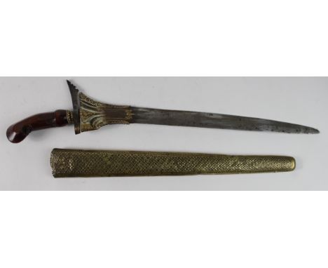 Kris dagger with fine Damascus blade, circa late 19th Century, rounded tip, total length 46cm approx., in a worked brass scab