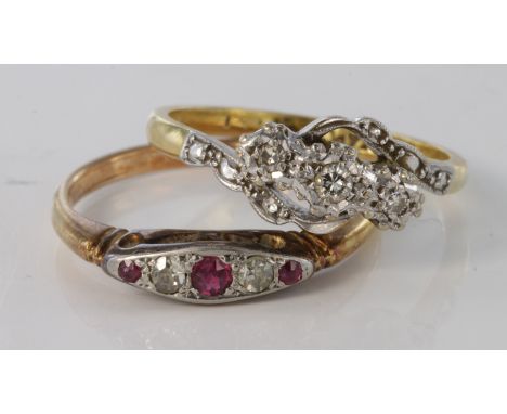 18ct diamond three stone crossover ring, size M, weight 3.8g. 18ct ruby and diamond ring size P, weight 2.9g.