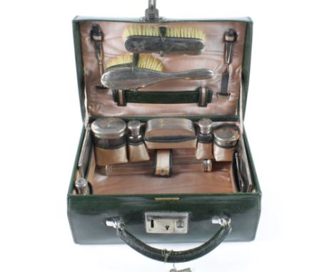 Thirteen piece silver hallmarked travelling vanity set, contained in a contemporary green leather case by Stewart Dawson & Co