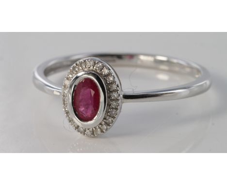 9ct white gold ruby and diamond oval ring, size N, weight 1.3g.