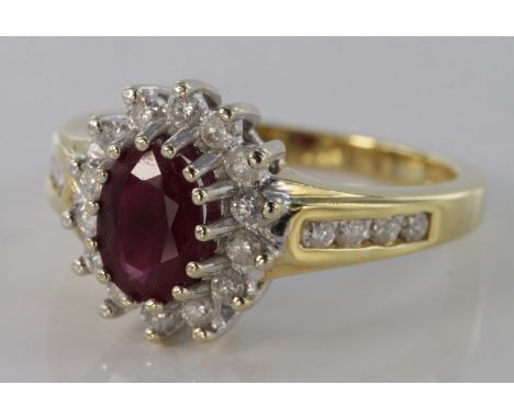 18ct yellow gold ruby and diamond cluster ring with channel set diamond shoulders, size J, weight 4.0g.