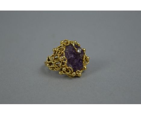 A LATE 20TH CENTURY 18CT GOLD AMETHYST AND DIAMOND RING, by Deakin & Francis, a large abstract design, amethyst druse crystal