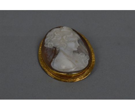 AN EARLY TO MID 20TH CENTURY CAMEO BROOCH, shell cameo depicting a lady in profile, textured surround, measuring approximatel