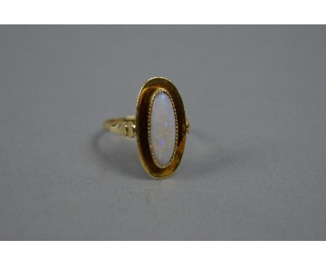 AN EARLY MID 20TH CENTURY OPAL SINGLE STONE RING, opal measuring approximately 15mm x 6mm, bead set to a plain polished head,