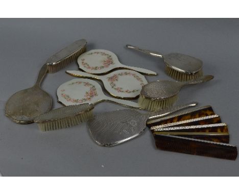 THREE ELIZABETH II SILVER AND WHITE ENAMEL HAND MIRRORS, decorated with a dog rose design, maker Elkington & Co, Birmingham 1