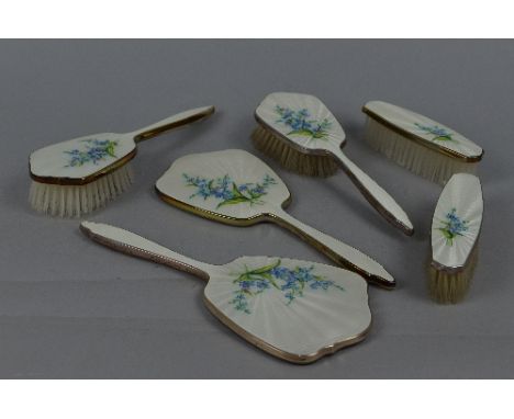 AN ELIZABETH II SILVER AND WHITE ENAMEL SIX PIECE DRESSING TABLE SET, decorated with a spray of forget me nots, makers Elking