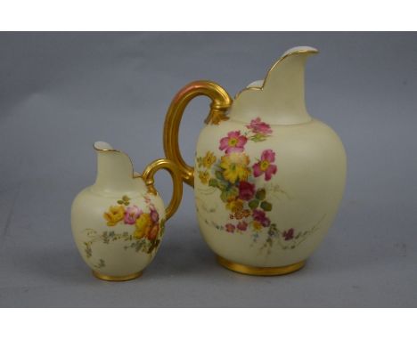 A GRADUATED SET OF TWO ROYAL WORCESTER IVORY GROUND JUGS OF FLATBACK SHAPE, both painted with Summer flowers including roses,