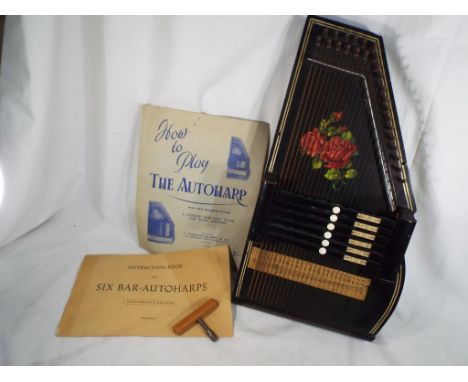 An early 20th century ebonized Auto Harp / Zither with floral decoration, tuning key and instruction book - Est £30 - £40